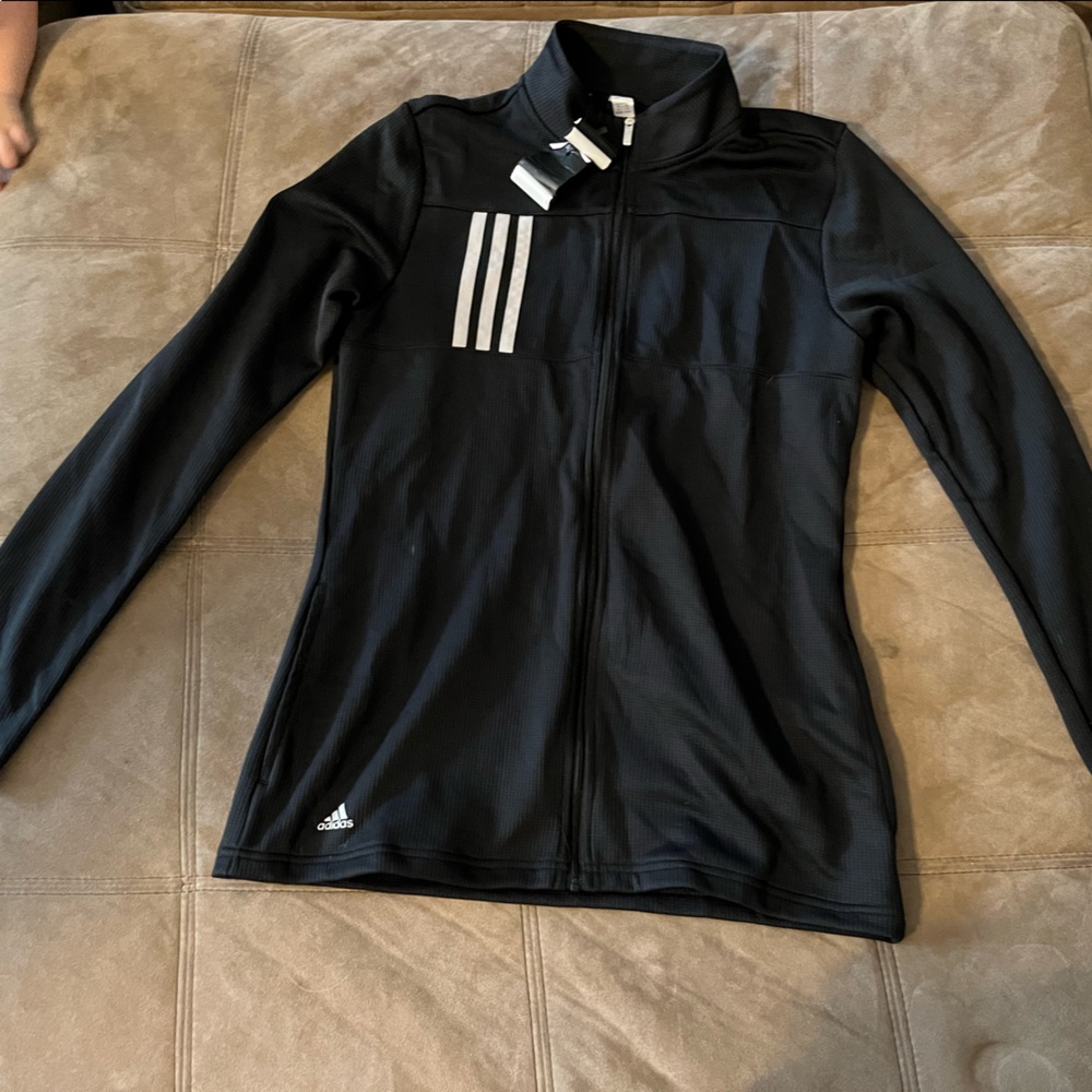 Adidas jacket with tags. Never worn. Has an embellishment on the sleeve.